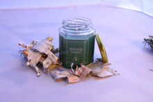 Load image into Gallery viewer, A green hexagonal candle surrounded by birch bark shavings. The label reads: "The Wayside Wizard", "Endless Forest", "Hand-poured soy wax candles".