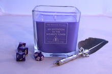 Load image into Gallery viewer, The Large Wayside Wizard themed dnd candle - an invitation to the wizards tower. There are a few dice scattered on the table top and a quill.