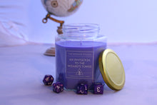 Load image into Gallery viewer, The medium sized 16oz jar of the Wayside Wizard's themed dnd candle - An invitation to the Wizard's tower. A globe sits unfocused in the background and dice are scattered on the tabletop. The label reads 'The Wayside Wizard', then 'An Invitation to the Wizard's Tower' and in small text it says 'hand-poured soywax candles'